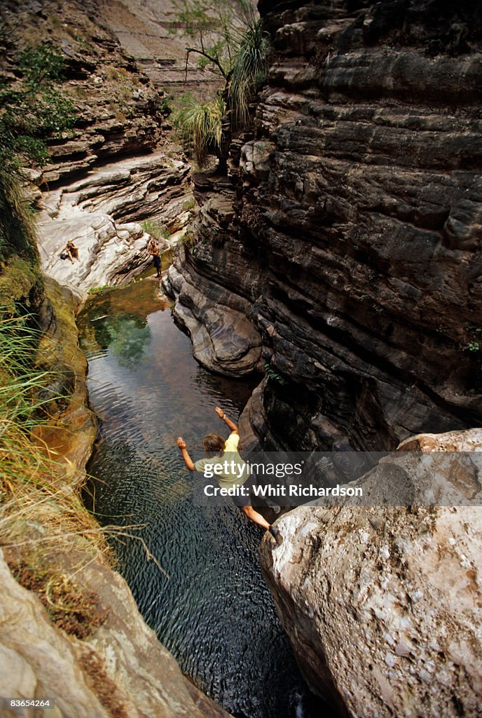 Woman jumps into water, Grand Canyon