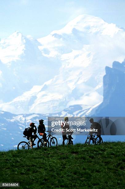 mountain bikers in morzine, france. - mont blanc massif stock pictures, royalty-free photos & images