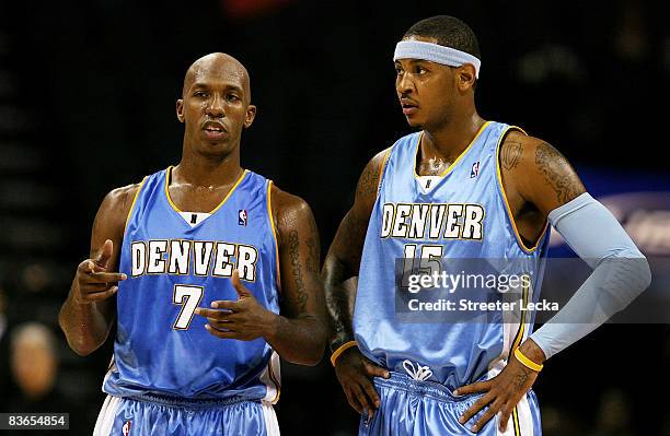 Chauncey Billups talks to teammate Carmelo Anthony of the Denver Nuggets during their game against the Charlotte Bobcats at Time Warner Cable Arena...