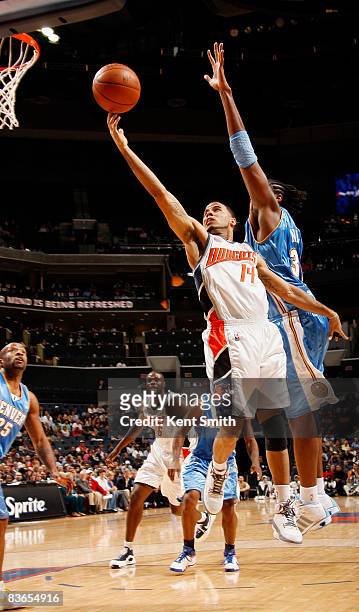 Nene of the Denver Nuggets guards against D.J. Augustin of the Charlotte Bobcats on November 11, 2008 at the Time Warner Cable Arena in Charlotte,...