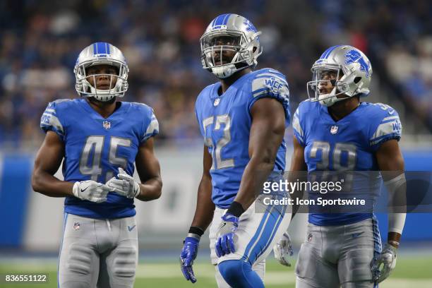 Detroit Lions linebacker Antwione Williams looks at the scoreboard along with teammates Detroit Lions safety Charles Washington and Detroit Lions...