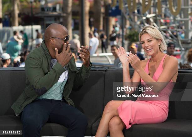 Akbar Gbaja-Biamila and Charissa Thompson visit "Extra" at Universal Studios Hollywood on August 21, 2017 in Universal City, California.