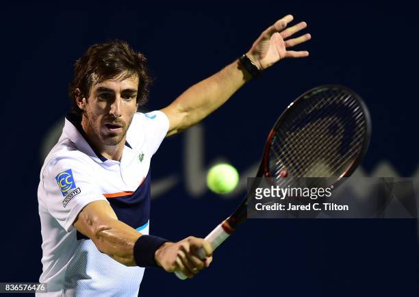Pablo Cuevas of Uruguay returns a shot from Jan-Lennard Struff of Germany during the third day of the Winston-Salem Open at Wake Forest University on...
