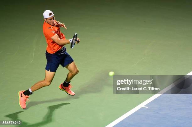 Jan-Lennard Struff of Germany returns a shot from Pablo Cuevas of Uruguay during the third day of the Winston-Salem Open at Wake Forest University on...