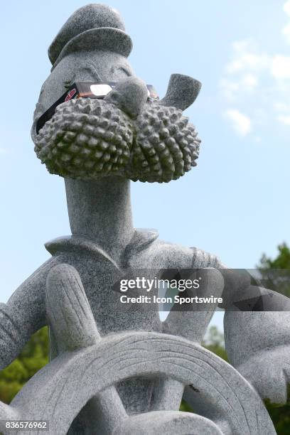 Popeye the Sailorman, a symbol of Chester, IL, sports a special pair of eclipse glasses during a total solar eclipse of the sun on August 21 as...