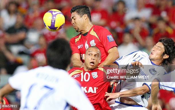 Adelaide United's Jose Cassio heads the ball ahead of teammate Cristiano and Gamba Osaka's Hashimoto Hideo in the second leg of the AFC Champions...