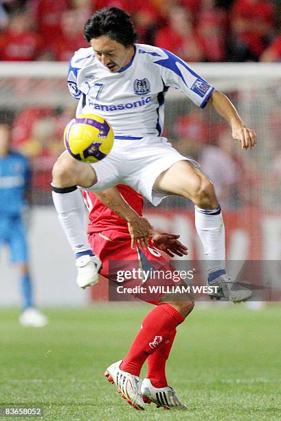 Gamba Osaka defenders Hashimoto Hideo steals the ball from Adelaide United's Jose Cassio in the second leg of the AFC Champions League final, being...