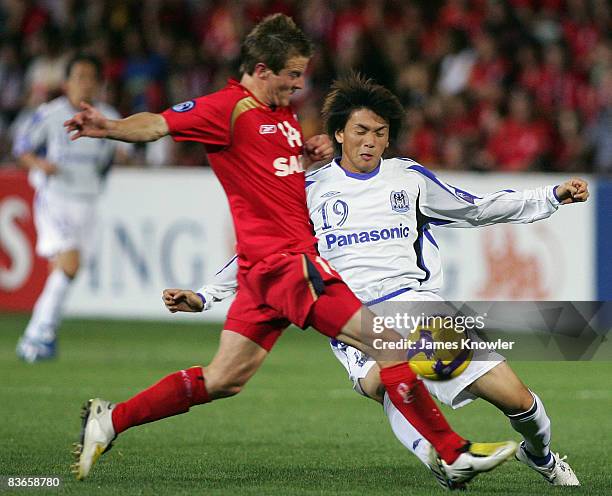 Takumi Shimohira of Gamba Osaka tackles Scott Jamieson of Adelaide United during the AFC Champions League Final second leg match between Adelaide...