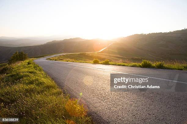 curvey road - sunset road stock pictures, royalty-free photos & images