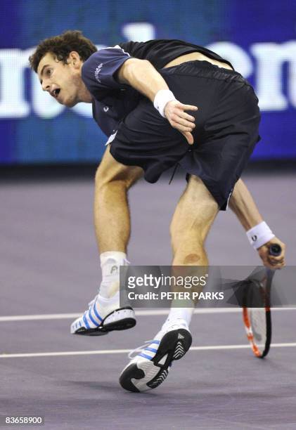 Andy Murray of Britain lunges for a return against Andy Roddick of the US in their singles match on the second day of the ATP Masters Cup tennis...