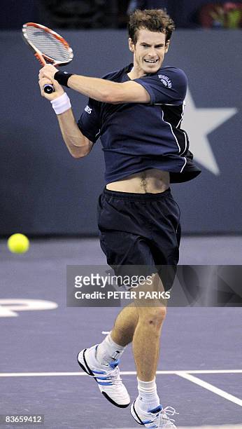 Andy Murray of Britain hits a return against Gilles Simon of France in their men's singles match on the fourth day of the ATP Masters Cup tennis...