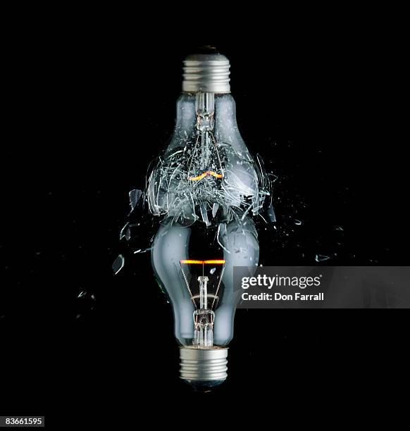 idea collision, broken bulb on top - broken lamp stockfoto's en -beelden