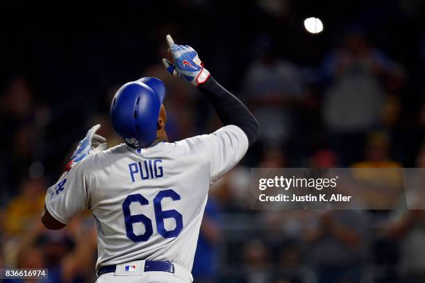 Yasiel Puig of the Los Angeles Dodgers reacts after hitting a solo home run in the twelfth inning against the Pittsburgh Pirates at PNC Park on...