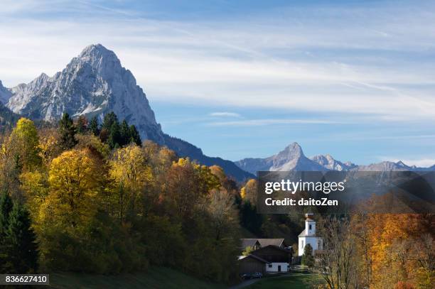 scenic view over wamberg village framed by trees in autumn colors and waxenstein mountain in the background, werdenfelser land, upper bavaria, germany - waxenstein fotografías e imágenes de stock