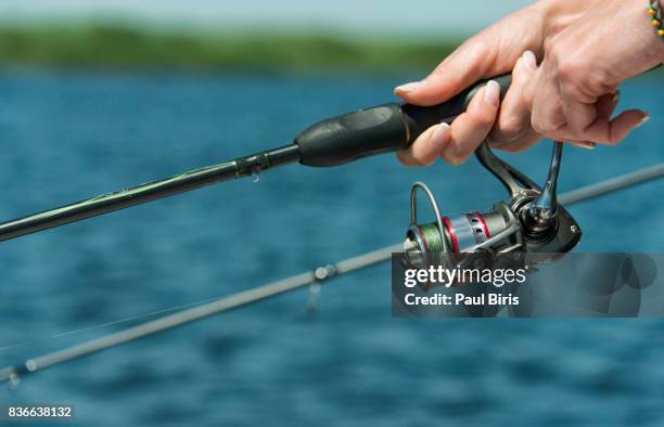 cropped shot of woman  fishing reel on beach, tulcea, danube delta, dobrudgea region, romania - tulcea foto e immagini stock