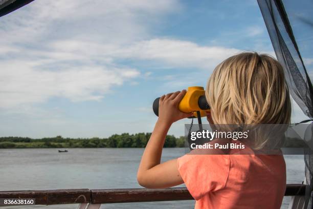 little boy with binoculars. wetland bird habitat, danube delta, romania - tulcea stock pictures, royalty-free photos & images