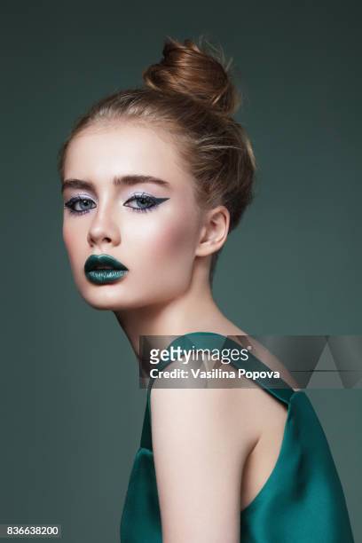 young beautiful woman in green dress - beautiful woman lipstick stock pictures, royalty-free photos & images