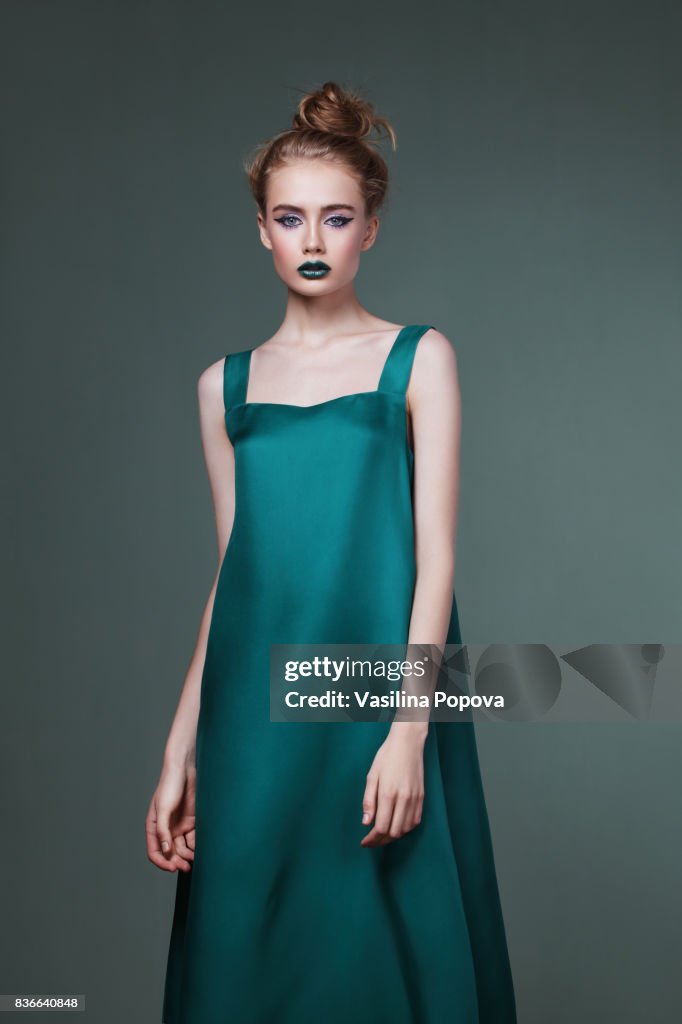 Young beautiful woman in green dress