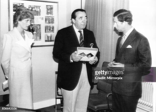 Robert Maxwell presenting Prince Charles with at gift Princess Diana watching at the Commonwealth games in 1986.