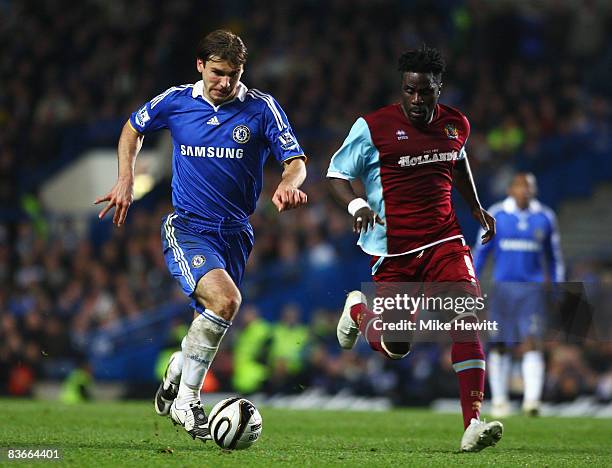 Branislav Ivanovic of Chelsea is challenged by Ade Akinbiyi of Burnley during the Carling Cup Fourth Round match between Chelsea and Burnley at...