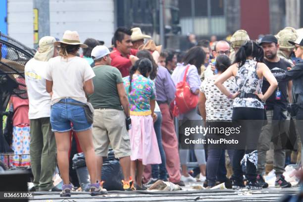 People acting as extras are seen on a street closed to the traffic during the filming of scenes of the movie &quot;Godzilla, King of the...