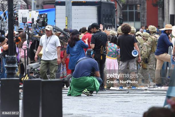 People acting as extras are seen on a street closed to the traffic during the filming of scenes of the movie &quot;Godzilla, King of the...