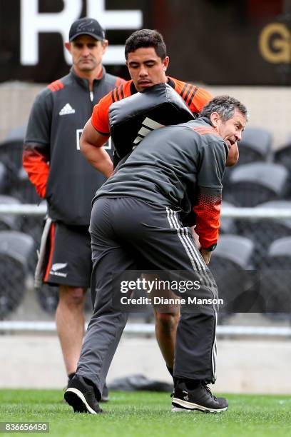 Anton Lienert-Brown of the All Blacks is tackle by Wayne Smith, assistant coach, during a New Zealand All Blacks Training Session on August 22, 2017...