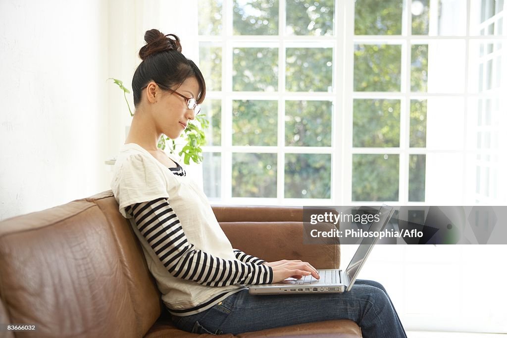 Young woman working from home on a laptop computer