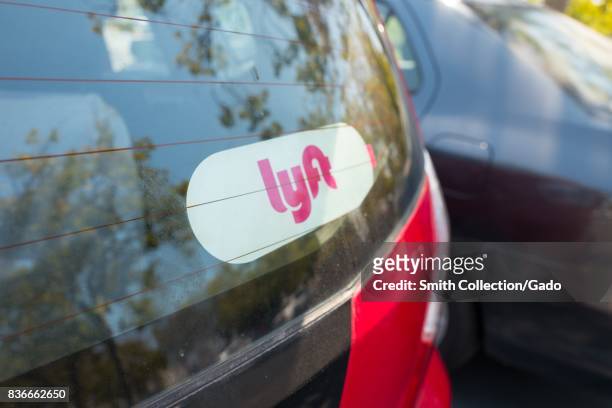 Sticker for Lyft on the back of a Lyft ride sharing vehicle in the Silicon Valley town of Santa Clara, California, August 17, 2017. .