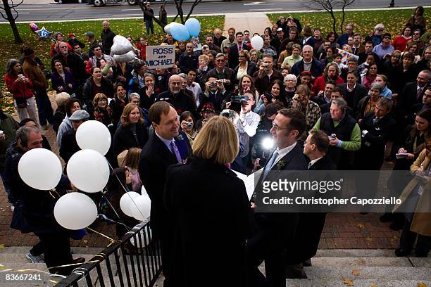 Michael Miller and Ross Zachs marry on the West Hartford Town Hall steps in front of a large crowd of same-sex marriage supporters and media after...
