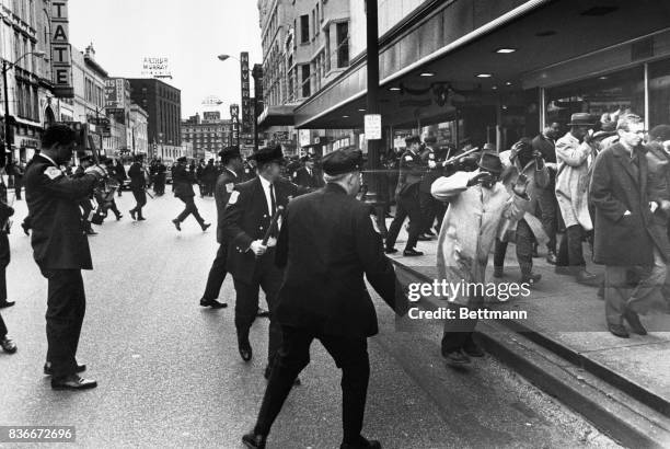 Police close in on group of striking garbage workers in downtown Memphis Feb. 23rd when a melee broke out during a peaceful demonstration by some...