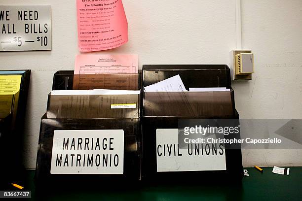 Marriage certificates that have two boxes marked "bride/groom/spouse" are displayed at the Vital Records Office at Hartford City Hall November 12,...