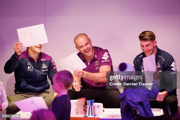 Billy Slater and teammates Nate Myles and Curtis Scott meet children during a Melbourne Storm NRL media opportunity at the Royal Children's Hospital...