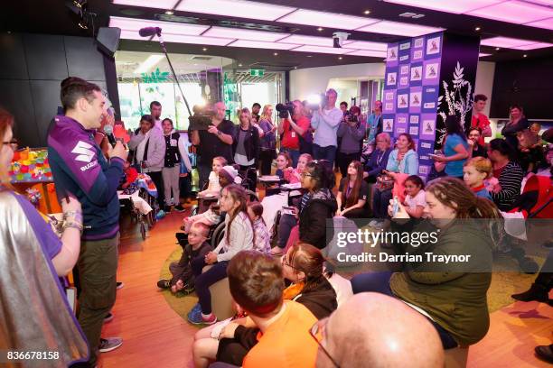 Billy Slater and teammates Nate Myles and Curtis Scott meet children during a Melbourne Storm NRL media opportunity at the Royal Children's Hospital...