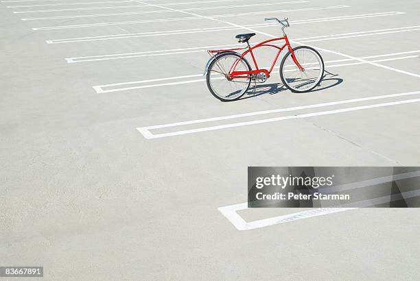 bike in empty parking lot. - out of context stock pictures, royalty-free photos & images