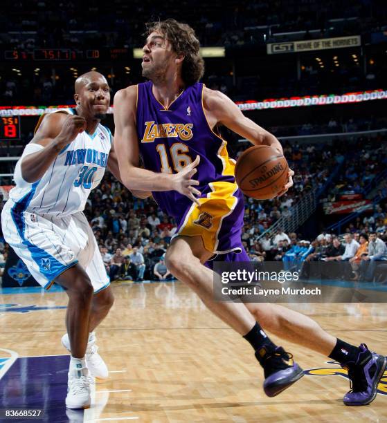 Pau Gasol of the Los Angeles Lakers drives around David West of the New Orleans Hornets on November 12, 2008 at the New Orleans Arena in New Orleans,...