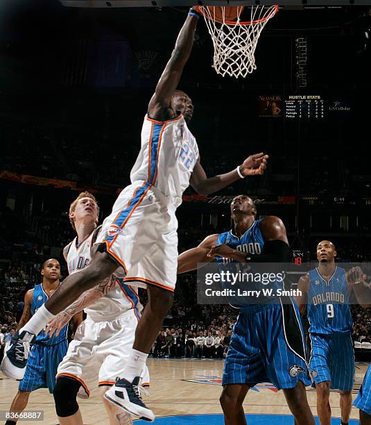 Jeff Green of the Oklahoma City Thunder completes a dunk against Dwight Howard of the Orlando Magic at the Ford Center November 12, 2008 in Oklahoma...