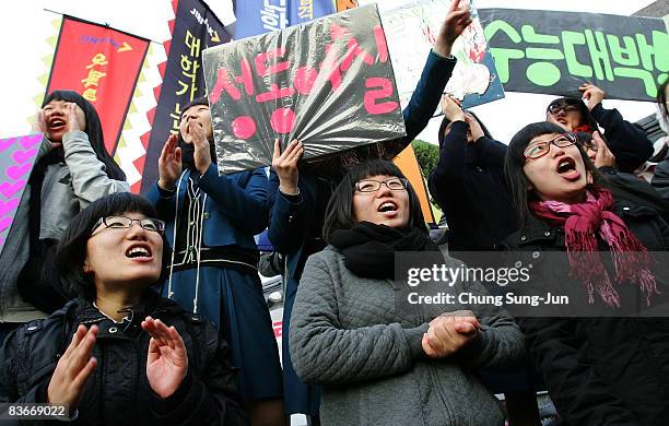South Korean high school girls cheer on their senior schoolmates taking the College Scholastic Ability Test at a school on November 13, 2008 in...