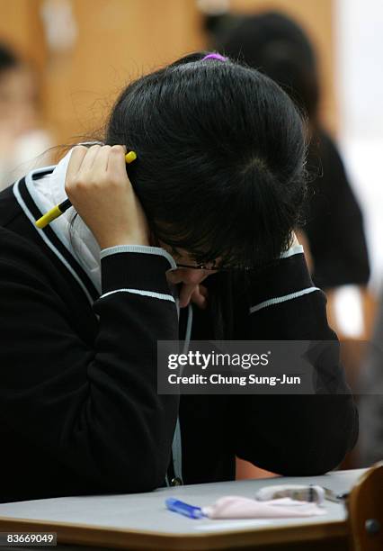 South Korean student takes her College Scholastic Ability Test at a school on November 13, 2008 in Seoul, South Korea. More than 580,000 high school...