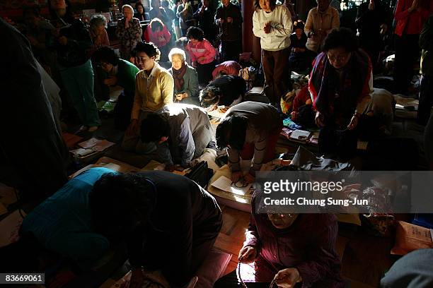South Korean parents pray for their children's success in the annual college entrance examination, at Chogye Buddhist temple on November 13, 2008 in...