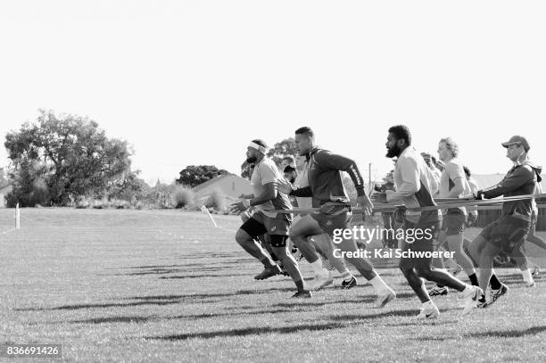 Sekope Kepu, Israel Folau and Marika Koroibete run during resistance training at an Australian Wallabies training session at Linwood Rugby Club on...