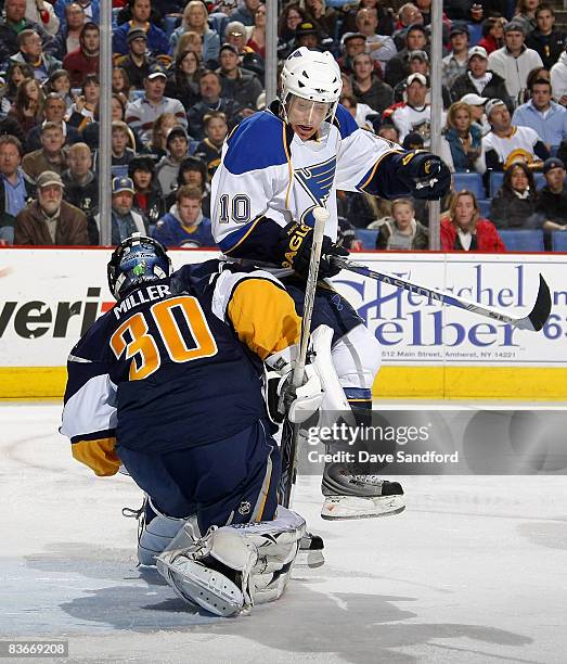 Andy McDonald of the St. Louis Blues interferes with goalie Ryan Miller of the Buffalo Sabres during their NHL game at HSBC Arena November 12, 2008...