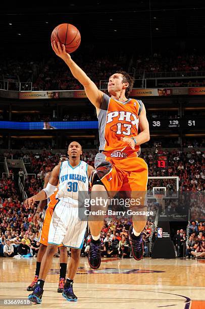 Steve Nash of the Phoenix Suns shoots a layup past David West of the New Orleans Hornets during the game at US Airways Center on October 30, 2008 in...