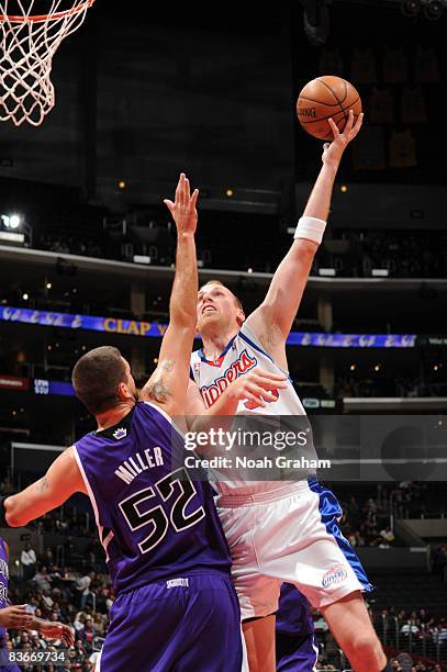 Chris Kaman of the Los Angeles Clippers goes up for a shot over Brad Miller of the Sacramento Kings at Staples Center on November 12, 2008 in Los...