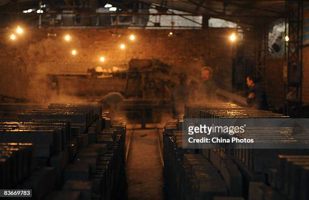Workers work overtime in a brick factory to produce bricks for the rebuilding of houses for Sichuan Earthquake survivers on November 12, 2008 in...