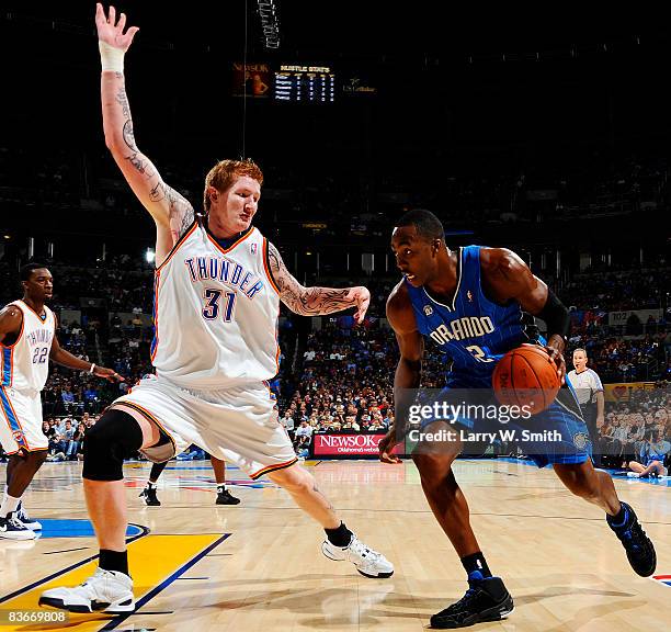 Dwight Howard of the Orlando Magic drives toward the basket while being guarded by Robert Swift of the Oklahoma City Thunder at the Ford Center...