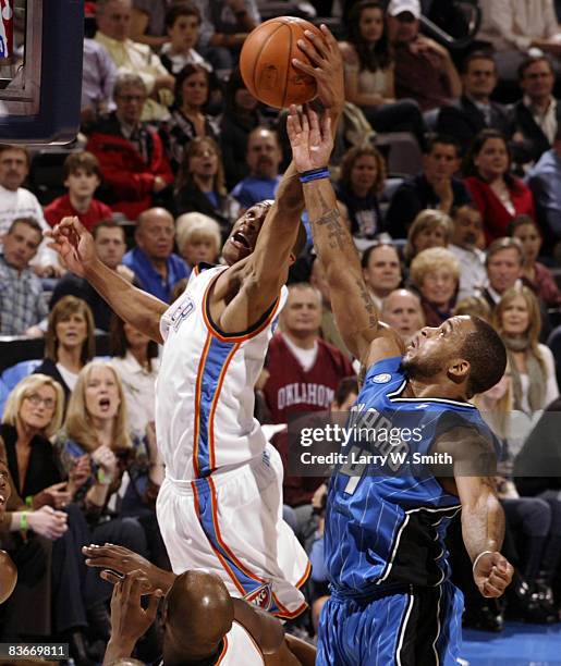 Russell Westbrook of the Oklahoma City Thunder grabs a rebound from Jameer Nelson of the Orlando Magic at the Ford Center November 12, 2008 in...