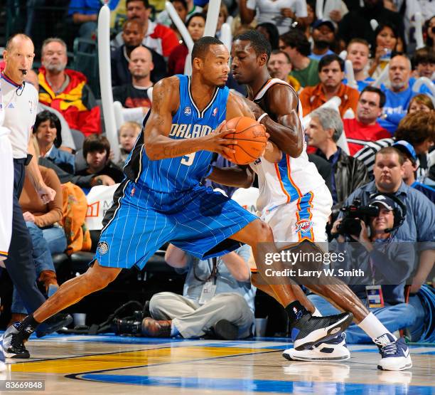 Rashard Lewis of the Orlando Magic drives toward the basket while being guarded by Jeff Green of the Oklahoma City Thunder at the Ford Center...