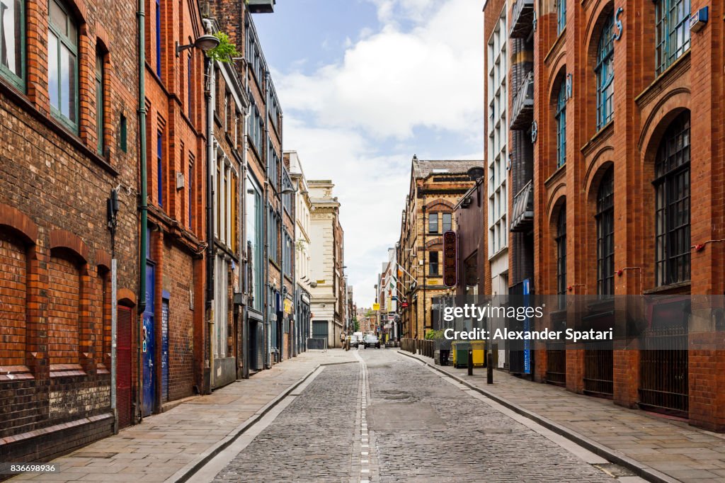 Old street with brick wall buildings in the downtown of Liverpool, England, UK