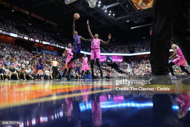 Danielle Robinson of the Phoenix Mercury drives to the basket defended by Jonquel Jones of the Connecticut Sun and Alyssa Thomas of the Connecticut...